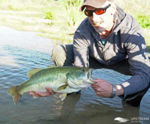 Upstream On The Fly Customer with a Largemouth Bass caught in North Texas while Fly Fishing
